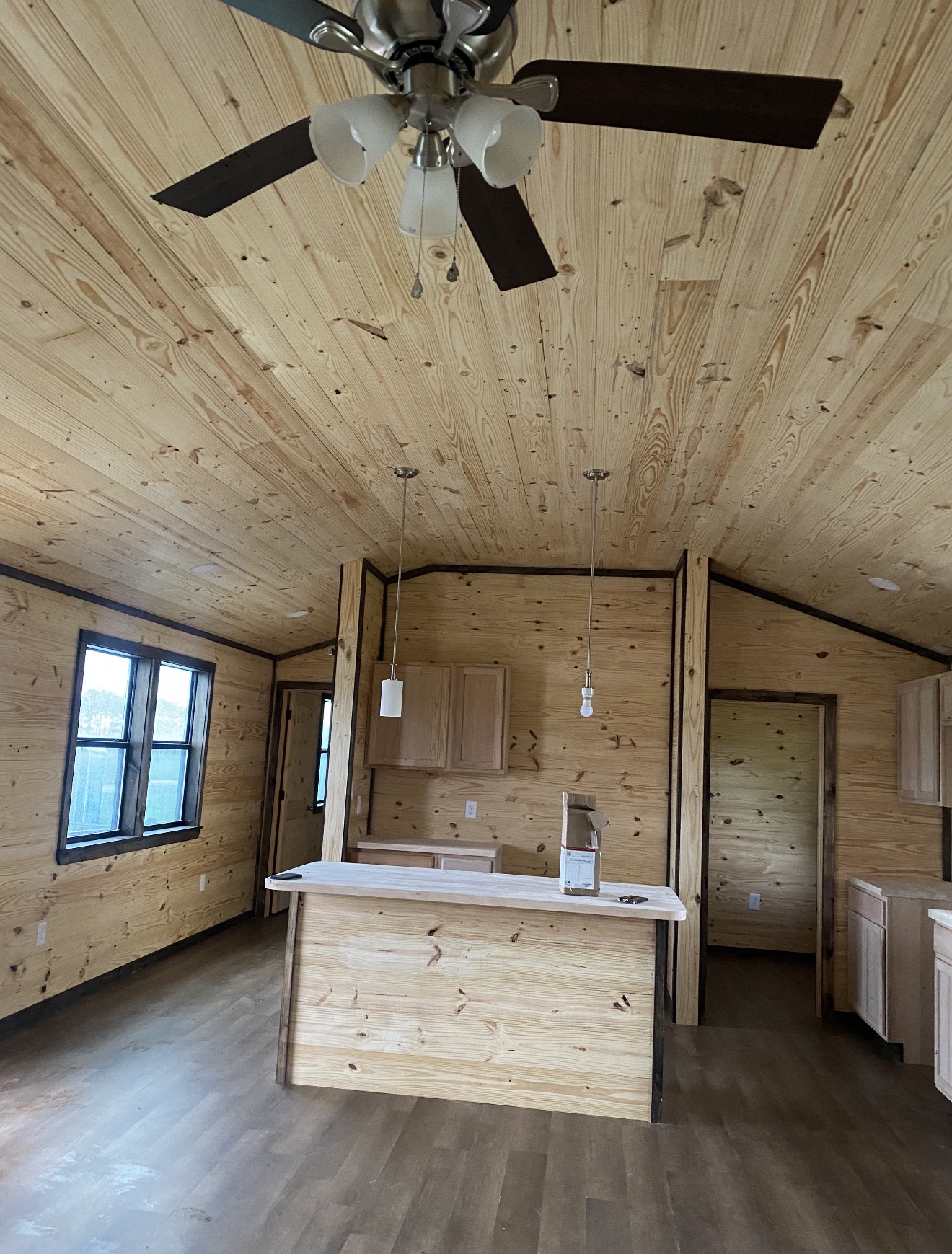 Tiny home interior with wood walls and kitchen